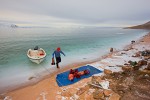 Inuit hunter bringing seal and walrus meat ashore after hunting